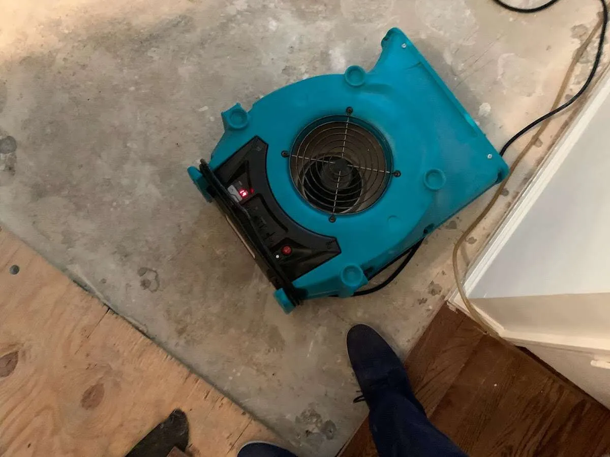 Air mover drying subfloor during Leak Detection & Repair in Winooski